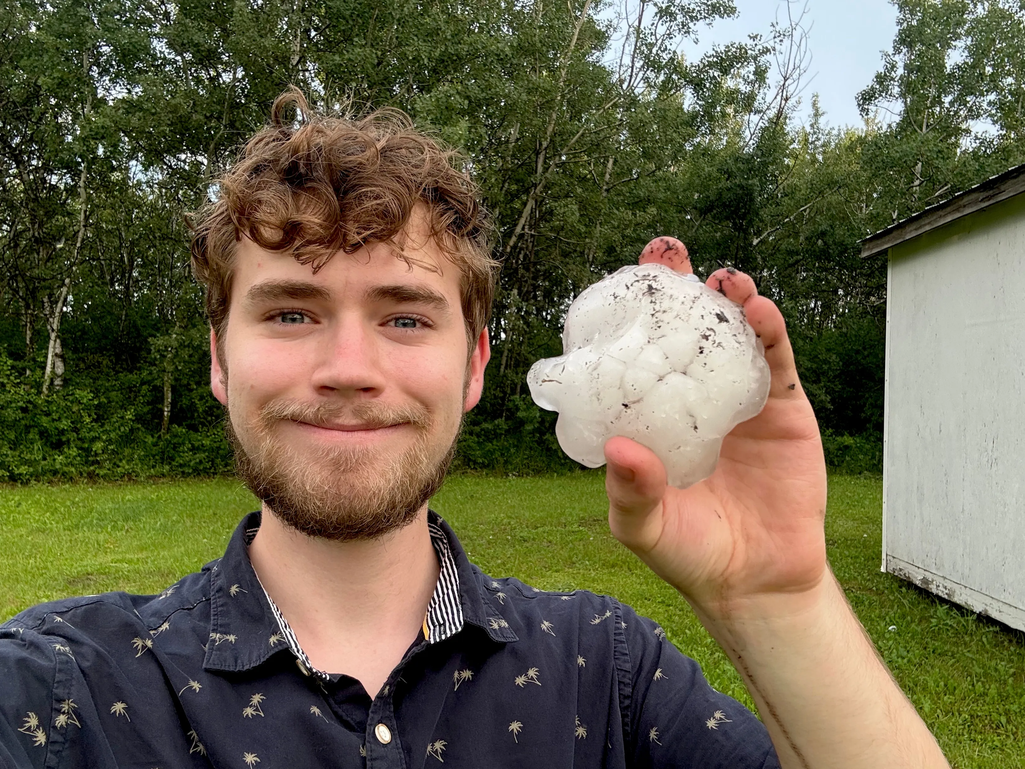 Ben Chernesky holding a hailstone near Glaslyn